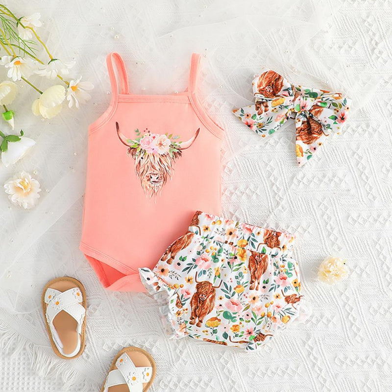 Effortless Summer Style: The Sling Hassle Suit with an adorable Scottish Highland Cow with flower crown.